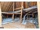 View of unfinished attic space with wooden beams and installed duct work at 125 Lake Park Dr, Sharpsburg, GA 30277