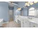Bathroom with a large double sink vanity, decorative lighting and ample counter space at 125 Lake Park Dr, Sharpsburg, GA 30277