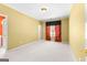 Spacious bedroom with a window, carpet floors, and bright yellow walls at 125 Lake Park Dr, Sharpsburg, GA 30277