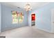 Bright bedroom with light-blue walls, neutral carpet and natural light from the window at 125 Lake Park Dr, Sharpsburg, GA 30277