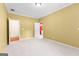 Open bedroom with a neutral color scheme, carpet floors, and two doorways at 125 Lake Park Dr, Sharpsburg, GA 30277