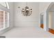 Formal dining room with elegant chandelier, wainscoting, and large windows for ample natural light at 125 Lake Park Dr, Sharpsburg, GA 30277