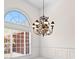 Dining room with chandelier and an arched window offering natural light and views of the exterior at 125 Lake Park Dr, Sharpsburg, GA 30277