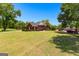 Charming home with lush lawn and mature trees, surrounded by a serene and well-maintained landscape at 125 Lake Park Dr, Sharpsburg, GA 30277
