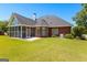 Beautiful brick home with a screened-in porch and well-maintained lawn at 125 Lake Park Dr, Sharpsburg, GA 30277