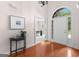 Inviting foyer with hardwood floors, an arched doorway, and views into the adjacent office space at 125 Lake Park Dr, Sharpsburg, GA 30277