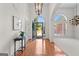 Inviting foyer with gleaming hardwood floors, arched doorway, and stylish lighting fixtures at 125 Lake Park Dr, Sharpsburg, GA 30277