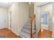Hallway features wood floors, and a carpeted staircase with decorative wood trim at 125 Lake Park Dr, Sharpsburg, GA 30277