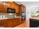 Traditional kitchen featuring custom wood cabinetry, built-in oven, hardwood flooring, and a breakfast nook at 125 Lake Park Dr, Sharpsburg, GA 30277