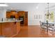 Eat-in kitchen area with wooden cabinets and hardwood floors at 125 Lake Park Dr, Sharpsburg, GA 30277