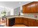 Kitchen featuring wood cabinets, stainless dishwasher, and eat-in breakfast area at 125 Lake Park Dr, Sharpsburg, GA 30277