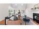 Spacious living room with hardwood floors, fireplace, and elegant decor with a view to the backyard at 125 Lake Park Dr, Sharpsburg, GA 30277