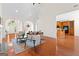 Open-concept living room featuring fireplace, hardwood floors, and arched doorways at 125 Lake Park Dr, Sharpsburg, GA 30277