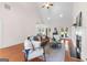 Open living room with hardwood floors, a fireplace, and views of the backyard through French doors at 125 Lake Park Dr, Sharpsburg, GA 30277