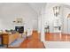 Bright and airy living room featuring hardwood floors, white trim, a fireplace and an open concept design at 125 Lake Park Dr, Sharpsburg, GA 30277