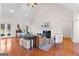 Open living room with hardwood floors, a fireplace, and high vaulted ceilings for plenty of light at 125 Lake Park Dr, Sharpsburg, GA 30277