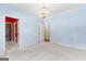 Light blue living room with an open doorway and an ornate chandelier at 125 Lake Park Dr, Sharpsburg, GA 30277
