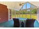 Screened-in porch with wicker furniture, offering a tranquil outdoor living space at 125 Lake Park Dr, Sharpsburg, GA 30277