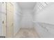 Spacious walk-in closet with multiple shelves and ample storage space at 125 Lake Park Dr, Sharpsburg, GA 30277
