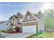 Two-story brick home featuring an attached two-car garage and a well-manicured front yard at 365 Othello Dr, Hampton, GA 30228