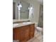 Bathroom featuring double vanity, granite countertop, and tiled walk-in shower at 1503 Wingate Way # 1503, Sandy Springs, GA 30350