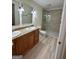 Bathroom featuring double vanity, granite countertop, and tiled walk-in shower at 1503 Wingate Way # 1503, Sandy Springs, GA 30350