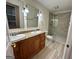 Bathroom featuring double vanity, granite countertop, and tiled walk-in shower at 1503 Wingate Way # 1503, Sandy Springs, GA 30350