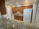 Spacious kitchen featuring granite countertops, wood cabinets and white appliances at 1503 Wingate Way # 1503, Sandy Springs, GA 30350