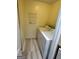Bright laundry room featuring modern washer and dryer, and shelving at 1503 Wingate Way # 1503, Sandy Springs, GA 30350