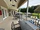 Outdoor patio area featuring black metal tables and chairs overlooking green space with gazebos at 1503 Wingate Way # 1503, Sandy Springs, GA 30350