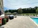 Community pool area with plenty of seating and shade for relaxation at 1503 Wingate Way # 1503, Sandy Springs, GA 30350