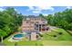 Expansive backyard with a putting green, covered patio, and luxurious in-ground pool at 4320 Blue Ridge Dr, Douglasville, GA 30135