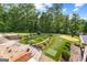 Landscaped backyard featuring putting green, stone retaining wall, and decorative rock at 4320 Blue Ridge Dr, Douglasville, GA 30135