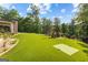 Backyard with manicured lawn and stone landscaping with mature trees at 4320 Blue Ridge Dr, Douglasville, GA 30135