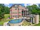 The outdoor pool with a covered patio, lounge area, and well-maintained landscaping at 4320 Blue Ridge Dr, Douglasville, GA 30135