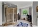Bright bathroom featuring a glass shower enclosure and large window with a view at 4320 Blue Ridge Dr, Douglasville, GA 30135