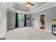 A spacious bedroom with a ceiling fan, large window, and ensuite bathroom at 4320 Blue Ridge Dr, Douglasville, GA 30135