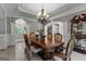 Bright dining area features an ornate chandelier and seamless flow to living spaces through archways at 4320 Blue Ridge Dr, Douglasville, GA 30135