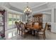 Elegant dining room with ornate chandelier, decorative china cabinet, and large window with backyard views at 4320 Blue Ridge Dr, Douglasville, GA 30135