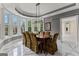 Inviting dining room with a long wood table, 8 upholstered chairs, and a bay window at 4320 Blue Ridge Dr, Douglasville, GA 30135