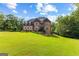 Well-maintained home with a pristine lawn, mature trees, and classic architectural details at 4320 Blue Ridge Dr, Douglasville, GA 30135