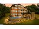 Beautiful view of home's exterior highlighting the pool, outdoor seating area, and manicured landscaping at 4320 Blue Ridge Dr, Douglasville, GA 30135