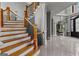 Elegant foyer showcasing hardwood staircase with wrought iron details and classic trim work at 4320 Blue Ridge Dr, Douglasville, GA 30135