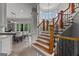 Grand foyer showcasing a curved staircase, hardwood steps, wrought iron railing, and open access to the kitchen at 4320 Blue Ridge Dr, Douglasville, GA 30135