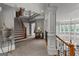 This foyer showcases a winding staircase, ornate iron railings, and elegant architectural details at 4320 Blue Ridge Dr, Douglasville, GA 30135