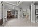 Expansive open-concept foyer and dining room area with decorative columns, archways and gleaming tiled floors at 4320 Blue Ridge Dr, Douglasville, GA 30135