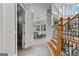 Open foyer with a view into the kitchen, featuring a staircase with wooden steps and a black iron railing at 4320 Blue Ridge Dr, Douglasville, GA 30135