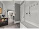 Hallway with a coat rack, a bench, light tile flooring, and a view into the kitchen at 4320 Blue Ridge Dr, Douglasville, GA 30135