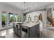The gray kitchen island features bar seating, a marble countertop, stainless steel appliances, and pendant lighting at 4320 Blue Ridge Dr, Douglasville, GA 30135