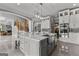 The kitchen features a gray island, a marble countertop, stainless steel appliances, and white cabinets at 4320 Blue Ridge Dr, Douglasville, GA 30135